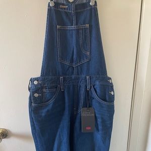 Blue Levi’s overalls.